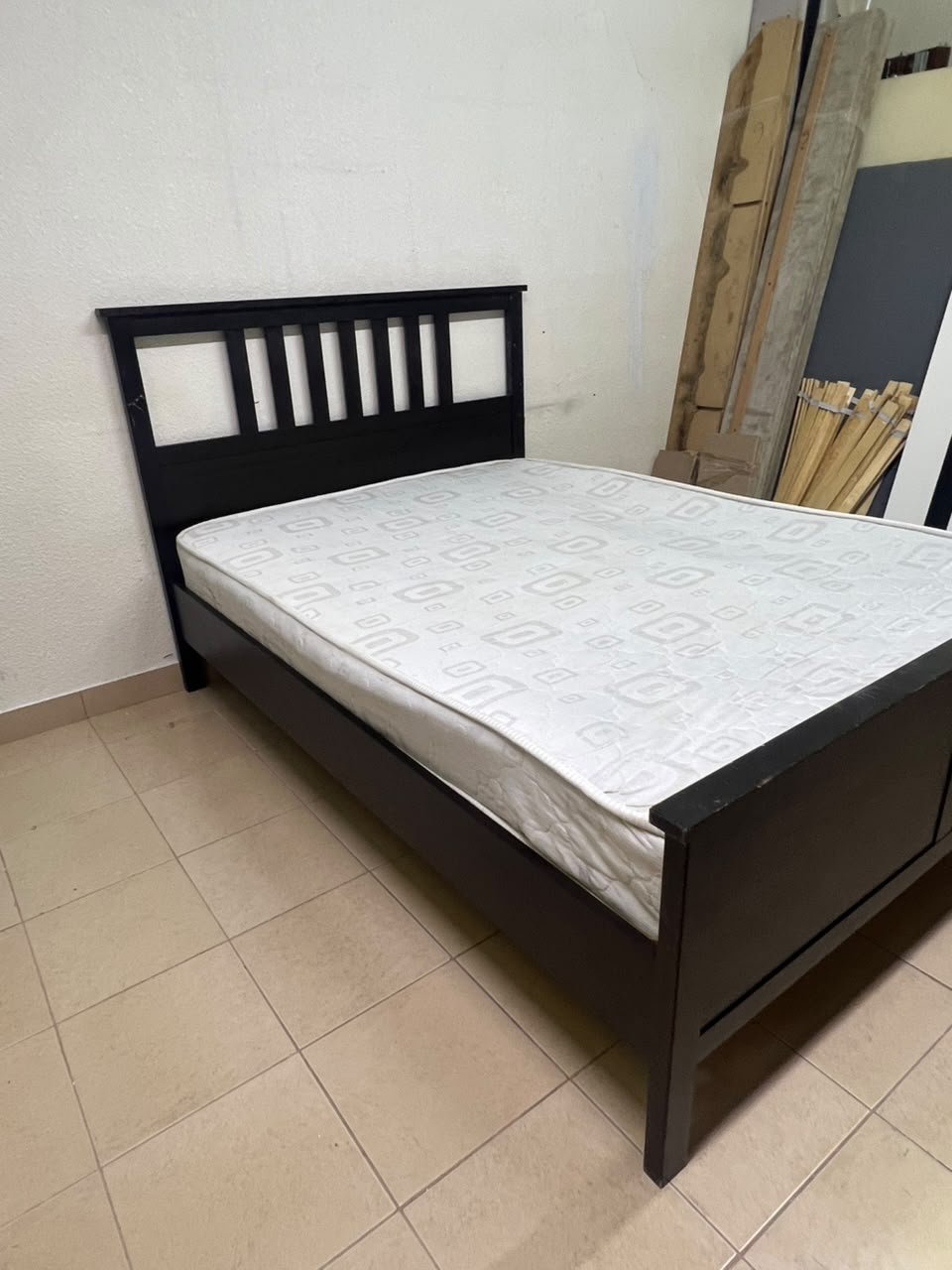 An IKEA "HEMNES" wooden bed frame in a black-brown finish, featuring a slatted headboard and a matching mattress. - Image 9