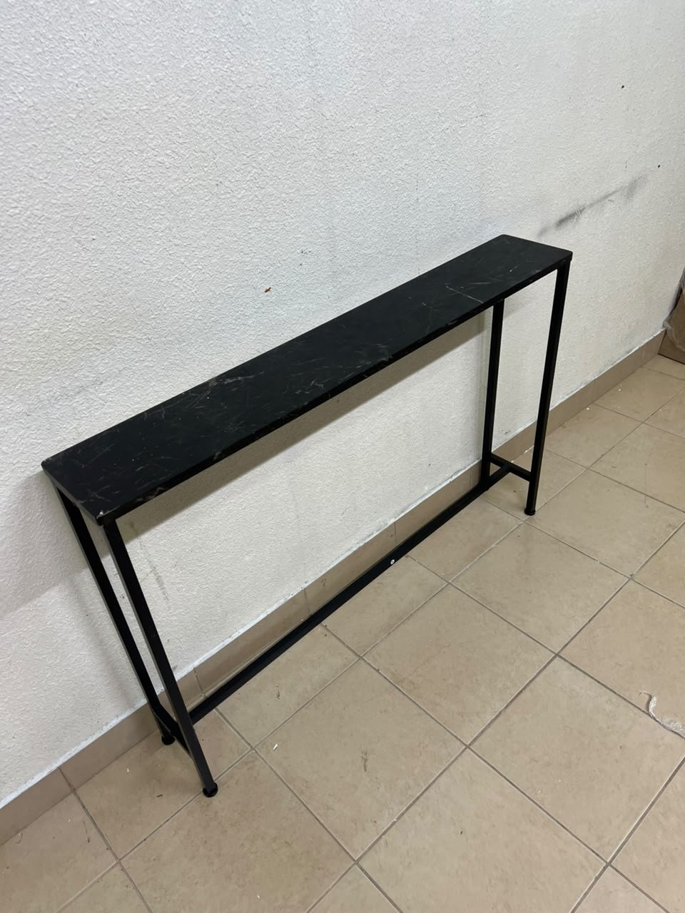 A console or sofa table—narrow and sleek—featuring a black metal frame and a rectangular top. - Image 5