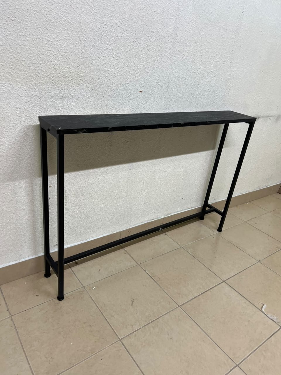 A console or sofa table—narrow and sleek—featuring a black metal frame and a rectangular top. - Image 6