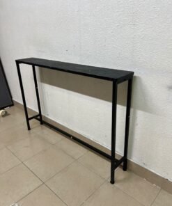 A console or sofa table—narrow and sleek—featuring a black metal frame and a rectangular top.