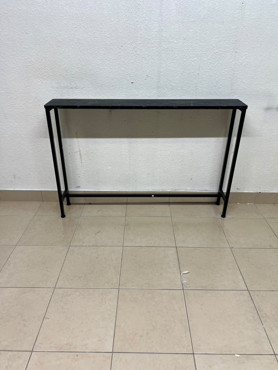 A console or sofa table—narrow and sleek—featuring a black metal frame and a rectangular top. - Image 8