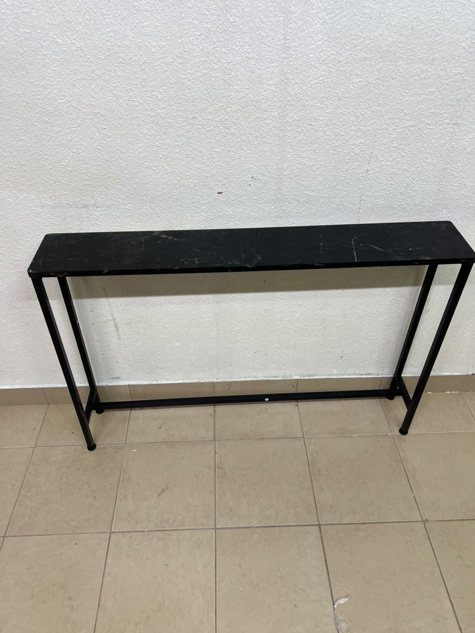 A console or sofa table—narrow and sleek—featuring a black metal frame and a rectangular top. - Image 9