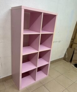 IKEA KALLAX shelving unit in pink, featuring a modular, 8-compartment cube design.