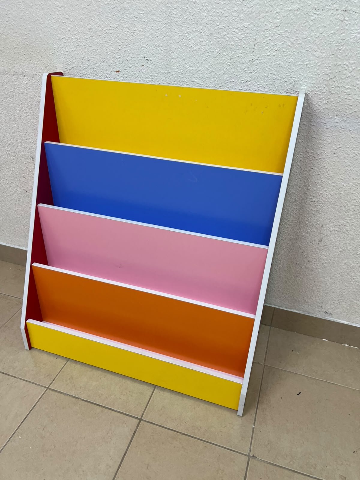 Colorful children's bookshelf with a multi-tiered wooden design.