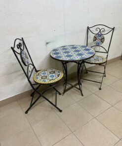 A three-piece black wrought-iron table and chair set, featuring blue and yellow ceramic mosaic tile accents on the round tabletop and the seats of the foldable chairs. - Image 7