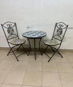 A three-piece black wrought-iron table and chair set, featuring blue and yellow ceramic mosaic tile accents on the round tabletop and the seats of the foldable chairs. - Image 11