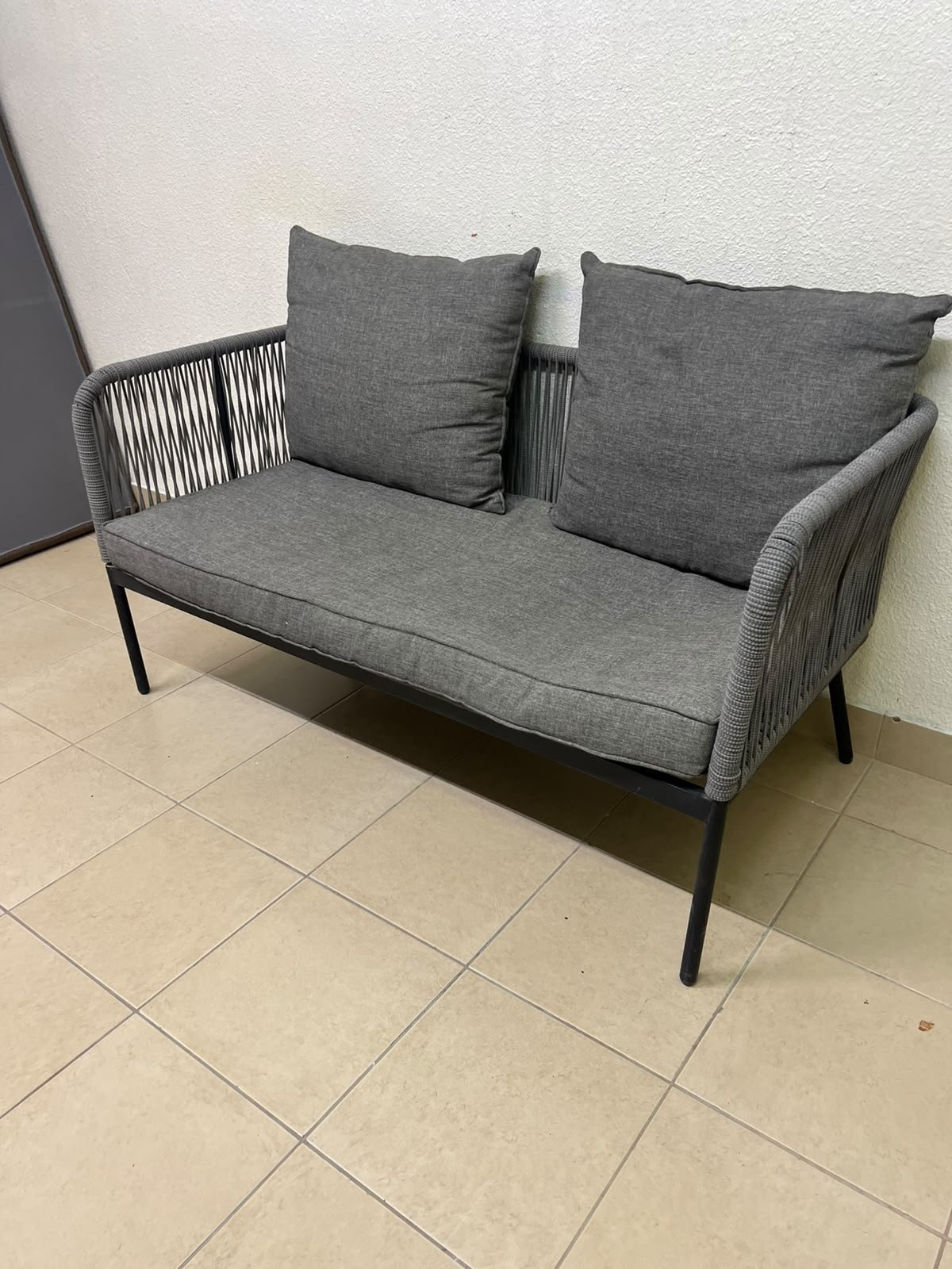 The two-seater outdoor sofa is a modern piece featuring a grey rope-woven design, a black metal frame, and matching back cushions. - Image 7