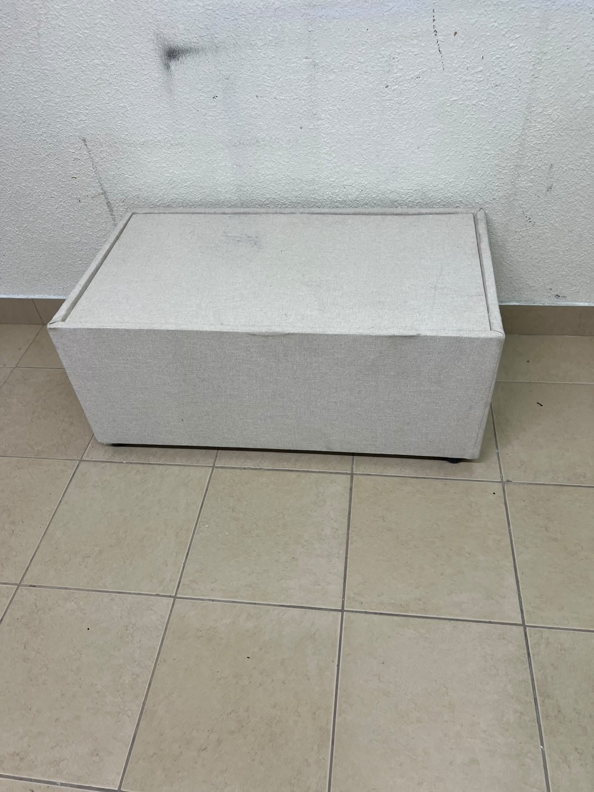 A coffee table upholstered in beige fabric with a textured feel and a neutral, linen-like appearance. - Image 9