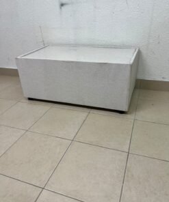 A coffee table upholstered in beige fabric with a textured feel and a neutral, linen-like appearance.