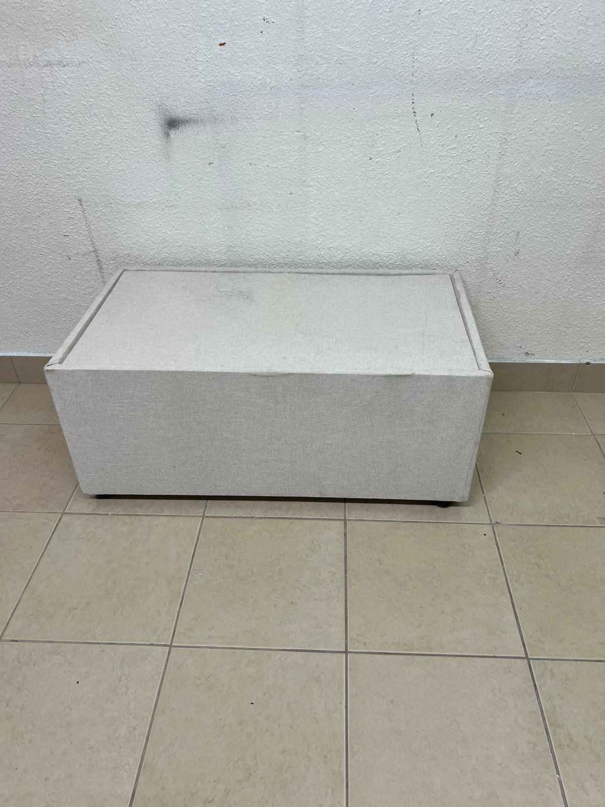 A coffee table upholstered in beige fabric with a textured feel and a neutral, linen-like appearance. - Image 3