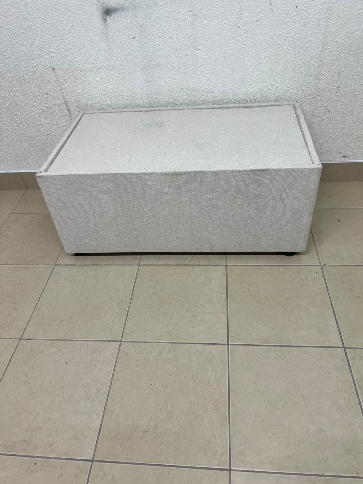 A coffee table upholstered in beige fabric with a textured feel and a neutral, linen-like appearance. - Image 6