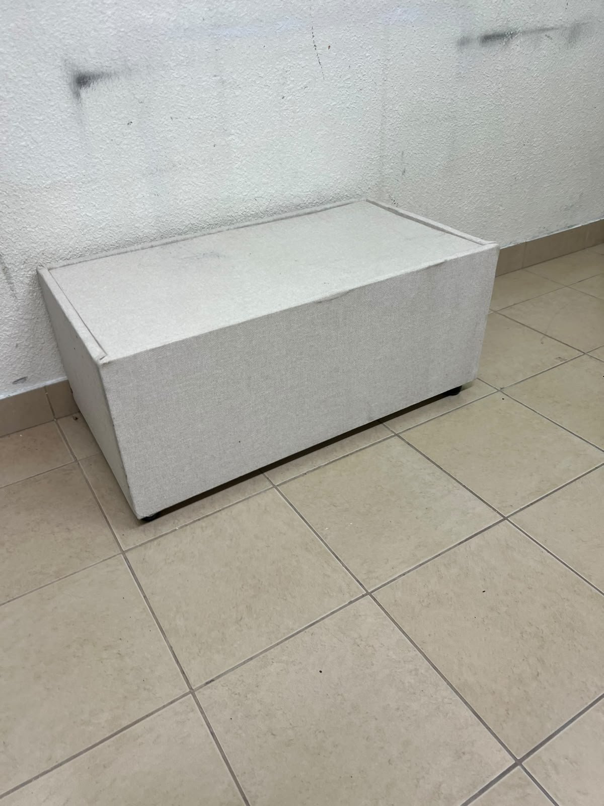 A coffee table upholstered in beige fabric with a textured feel and a neutral, linen-like appearance. - Image 8