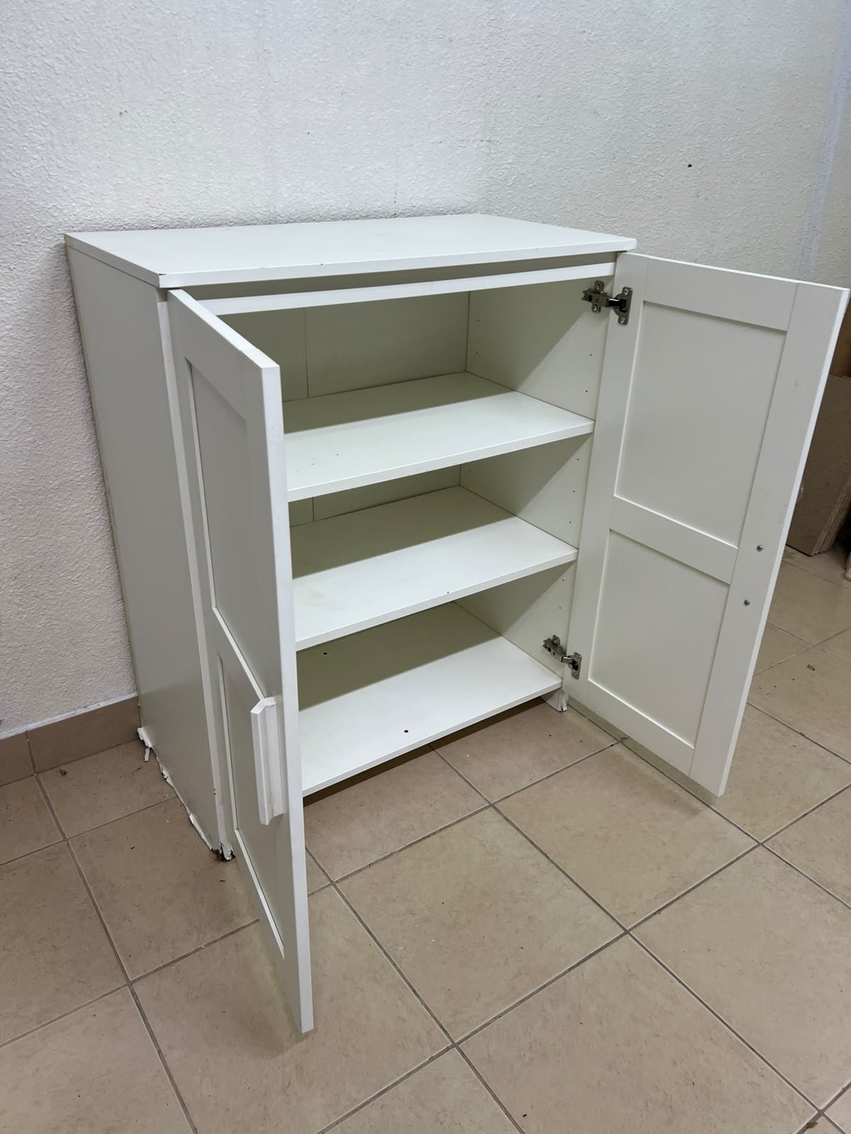 The white IKEA BRIMNES wardrobe features an elegant design with double paneled doors. - Image 9
