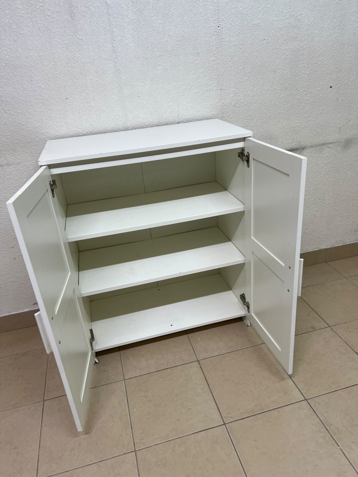 The white IKEA BRIMNES wardrobe features an elegant design with double paneled doors. - Image 10
