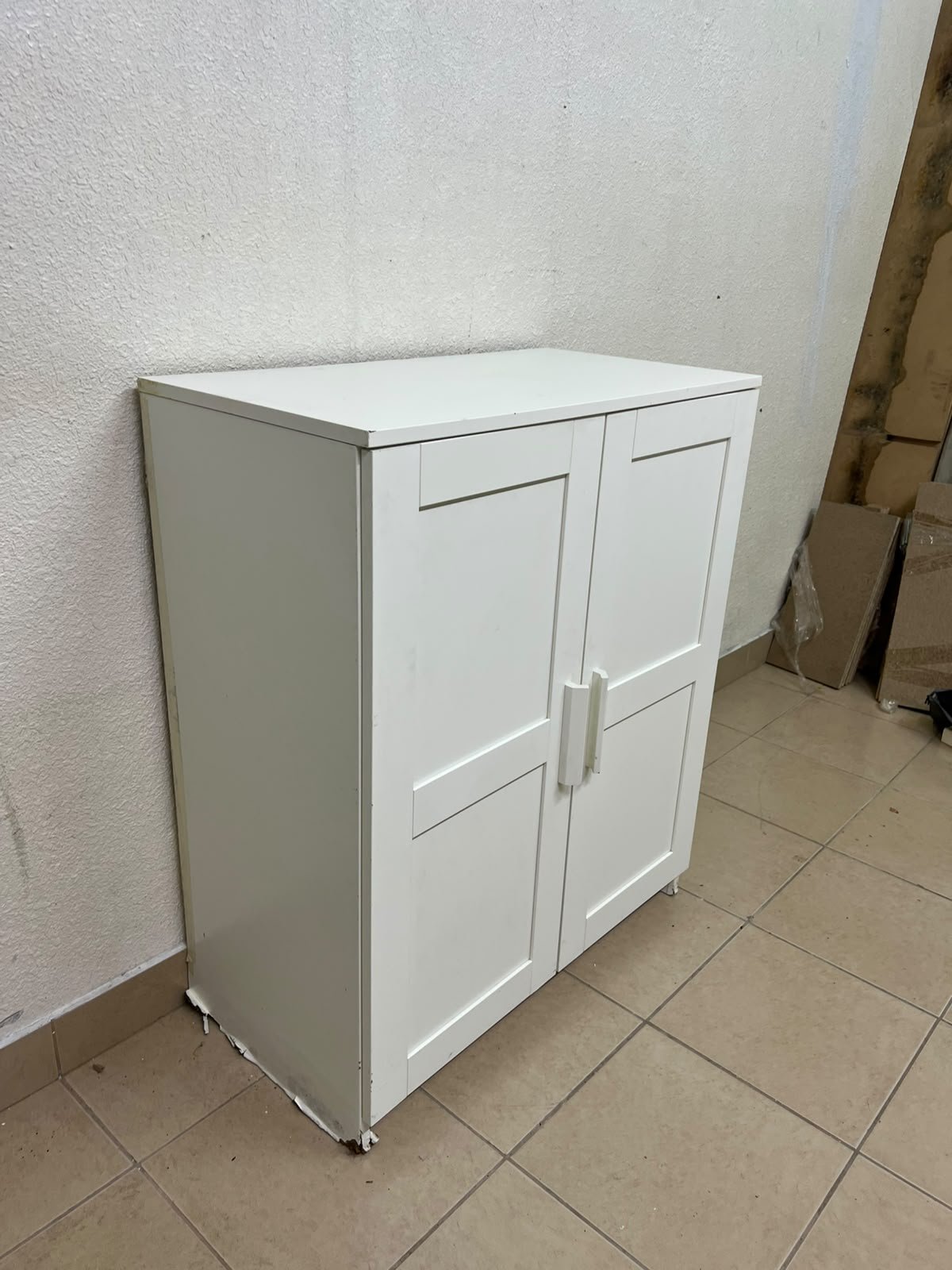 The white IKEA BRIMNES wardrobe features an elegant design with double paneled doors. - Image 2