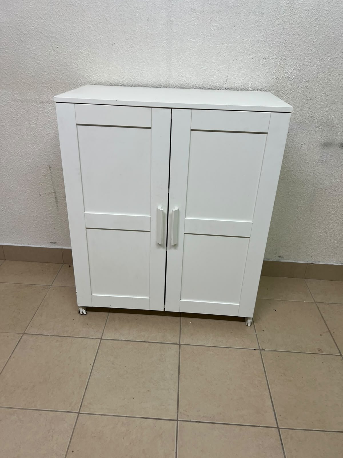The white IKEA BRIMNES wardrobe features an elegant design with double paneled doors. - Image 3