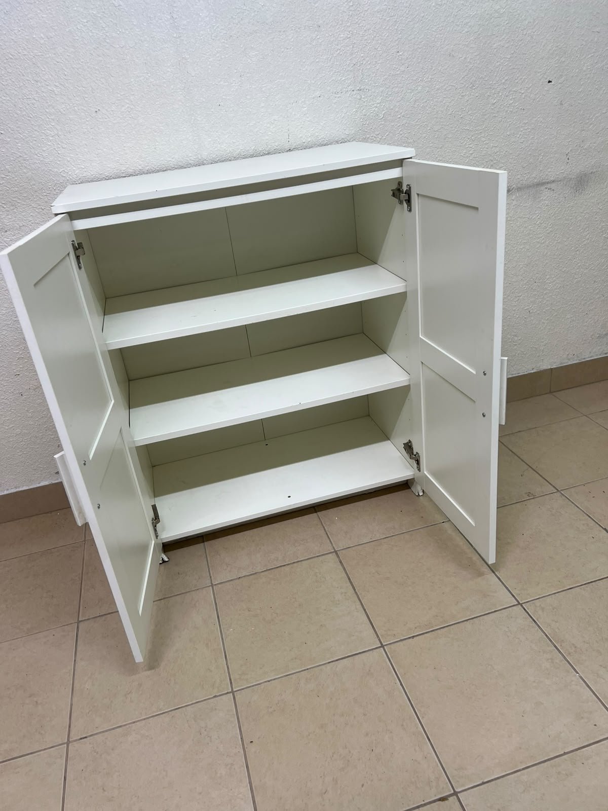 The white IKEA BRIMNES wardrobe features an elegant design with double paneled doors. - Image 5