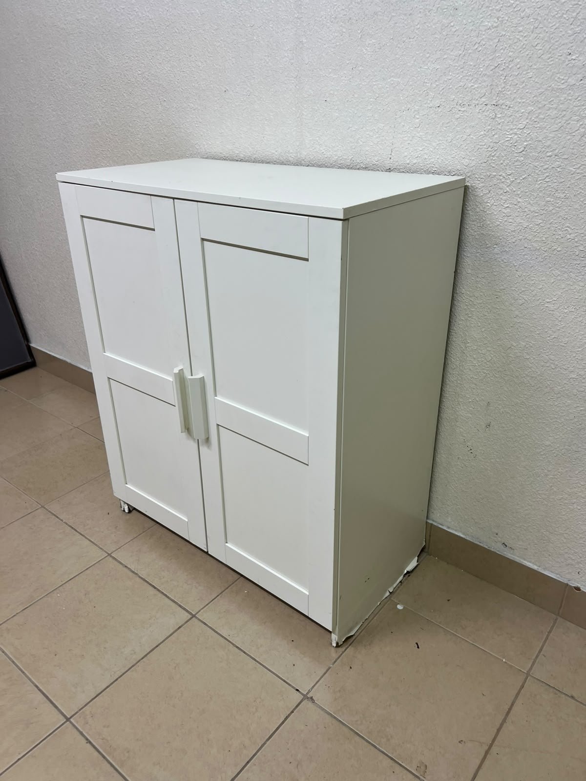 The white IKEA BRIMNES wardrobe features an elegant design with double paneled doors. - Image 7