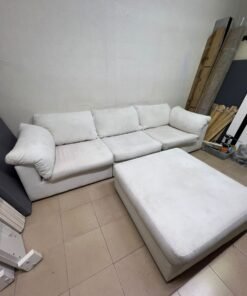 A modular white "Cloud-style" sectional sofa with a matching large ottoman, similar in design to options available at Danube Home.