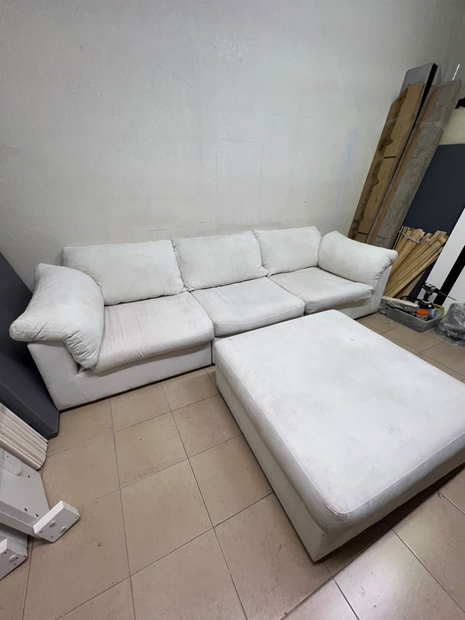 A modular white "Cloud-style" sectional sofa with a matching large ottoman, similar in design to options available at Danube Home.