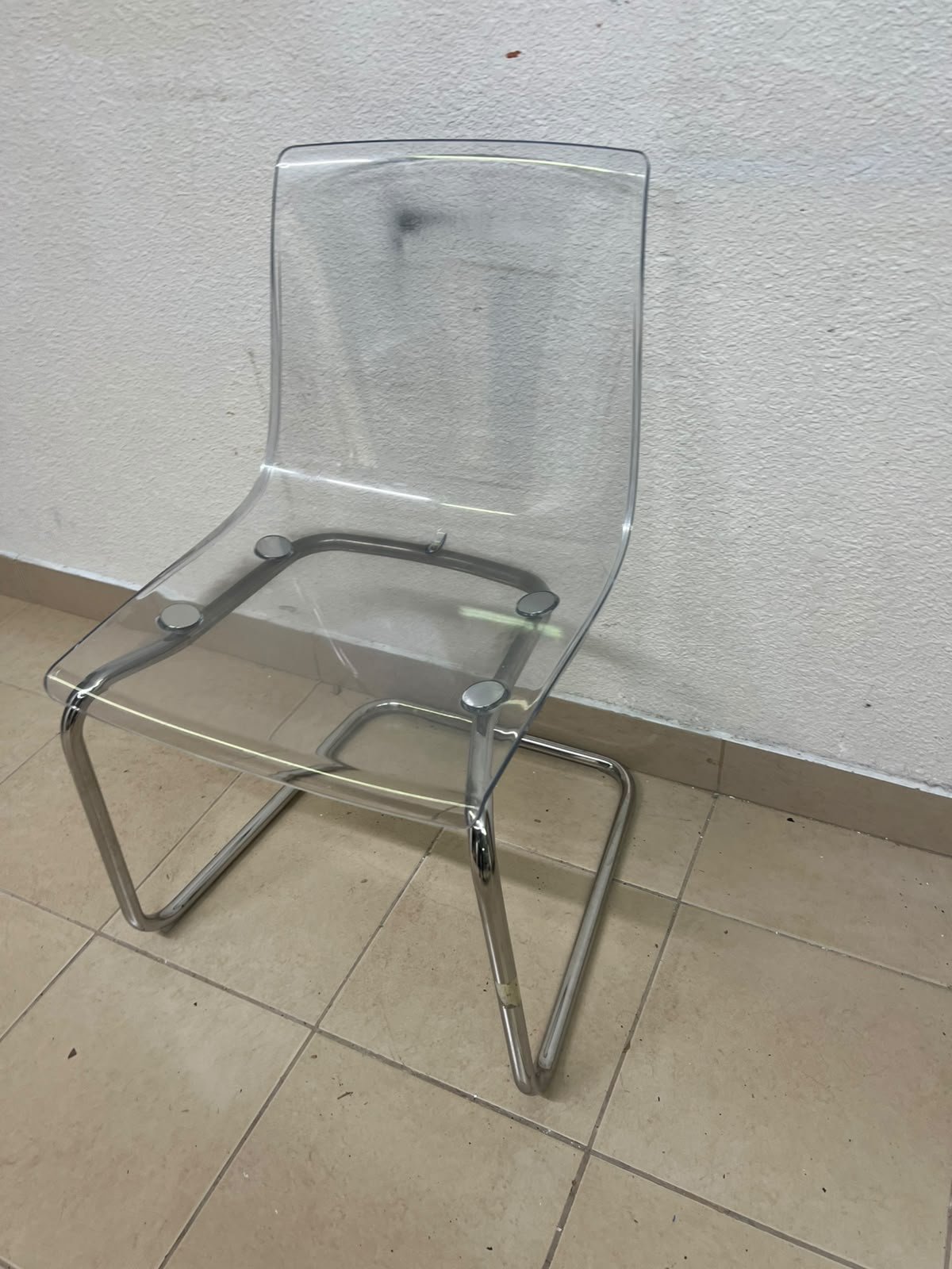 The IKEA "Tobias" chair, featuring a transparent acrylic seat and a chrome-plated steel frame. - Image 2