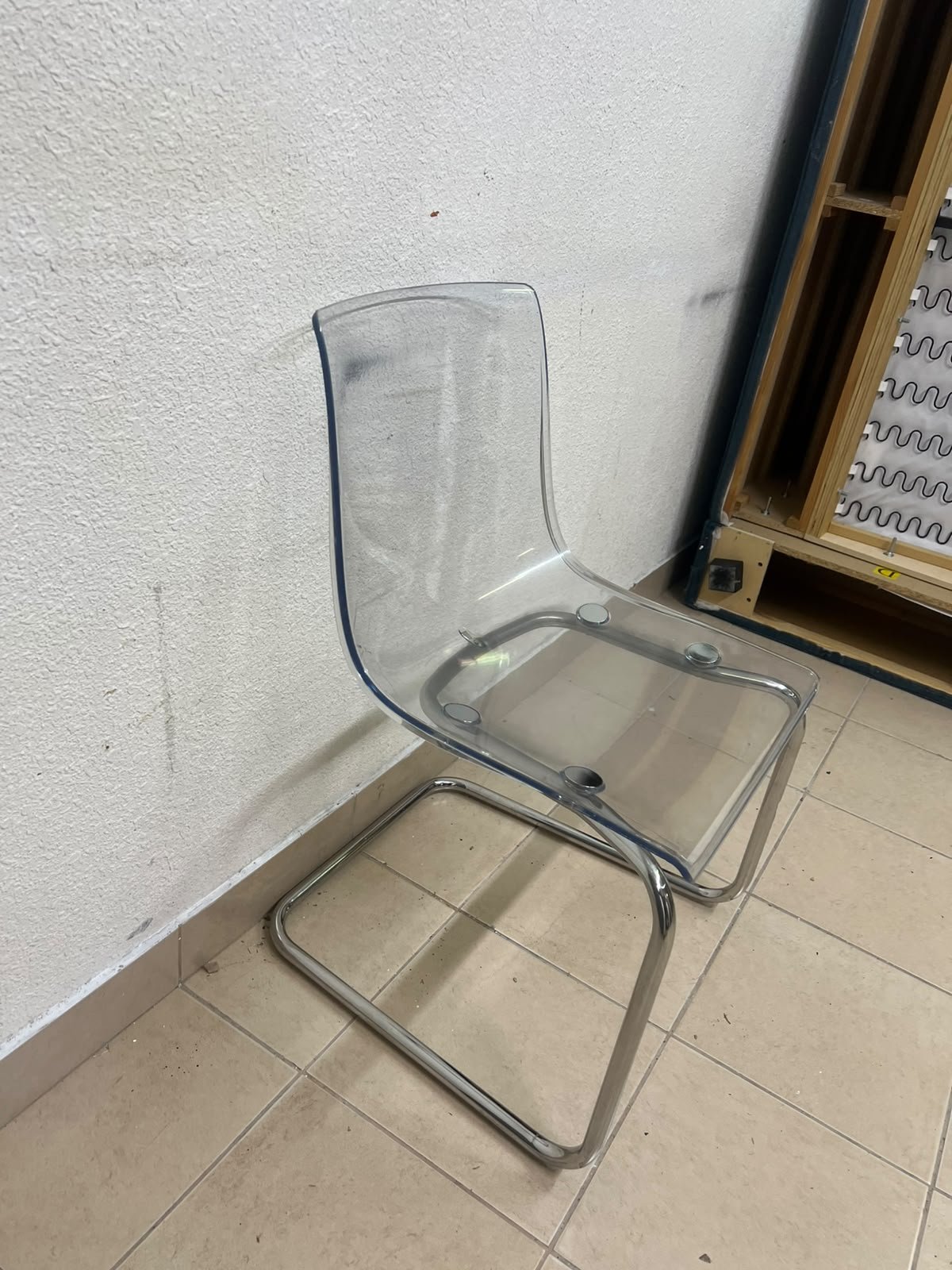 The IKEA "Tobias" chair, featuring a transparent acrylic seat and a chrome-plated steel frame. - Image 3