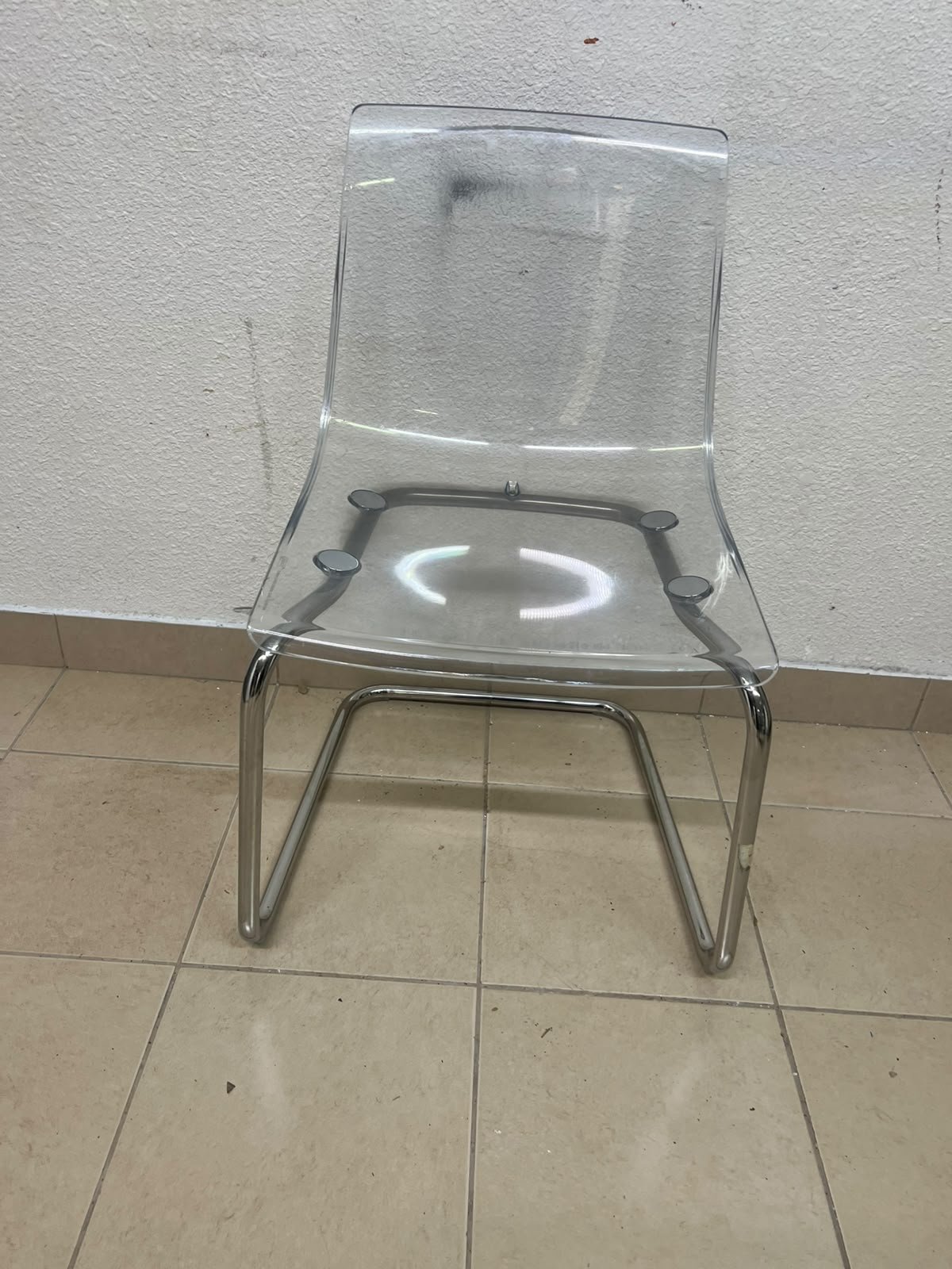 The IKEA "Tobias" chair, featuring a transparent acrylic seat and a chrome-plated steel frame. - Image 4