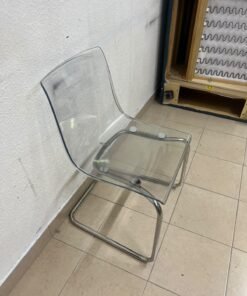 The IKEA "Tobias" chair, featuring a transparent acrylic seat and a chrome-plated steel frame.