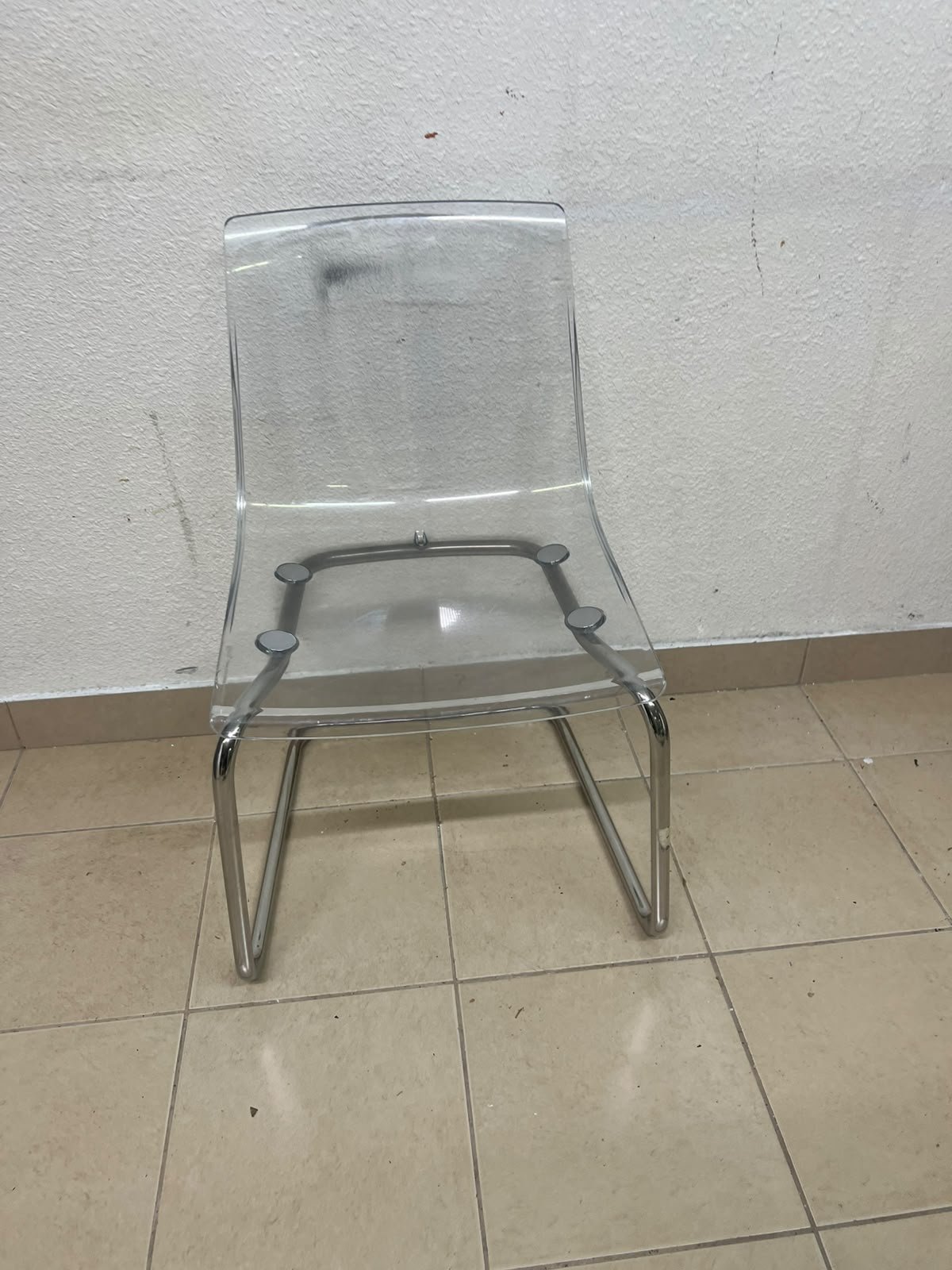 The IKEA "Tobias" chair, featuring a transparent acrylic seat and a chrome-plated steel frame. - Image 6