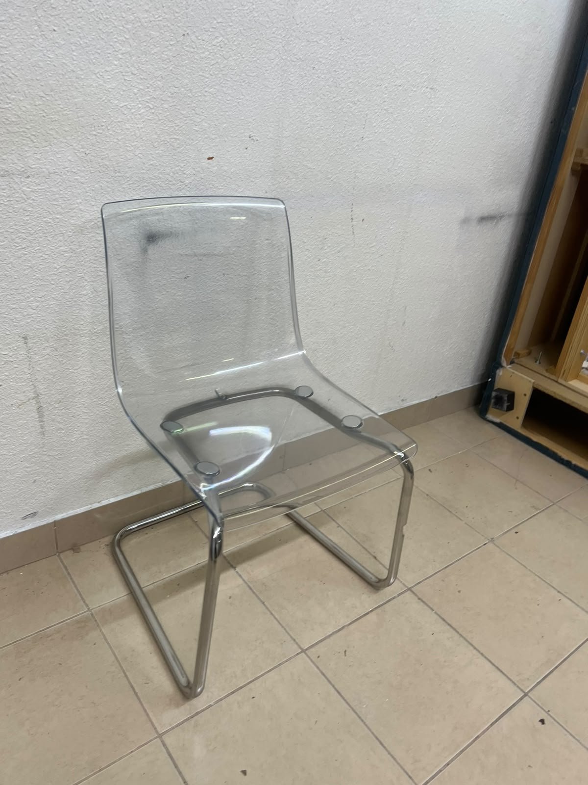The IKEA "Tobias" chair, featuring a transparent acrylic seat and a chrome-plated steel frame. - Image 7
