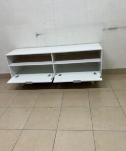 A modern, white, freestanding TV stand featuring angled legs and two large lower storage drawers, topped by open shelves. - Image 6