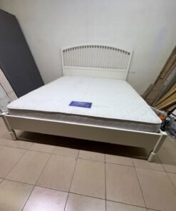 The white IKEA TYSSEDAL bed frame, featuring distinctive vertical wooden slats on the arched headboard and carved legs. - Image 3