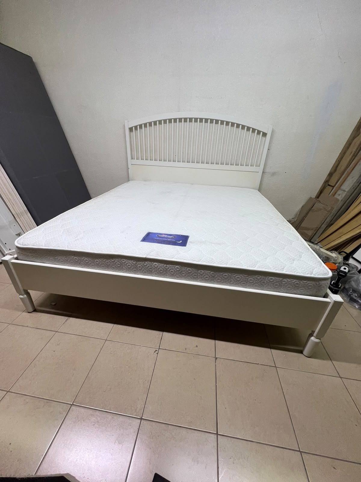 The white IKEA TYSSEDAL bed frame, featuring distinctive vertical wooden slats on the arched headboard and carved legs. - Image 3