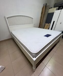 The white IKEA TYSSEDAL bed frame, featuring distinctive vertical wooden slats on the arched headboard and carved legs. - Image 4