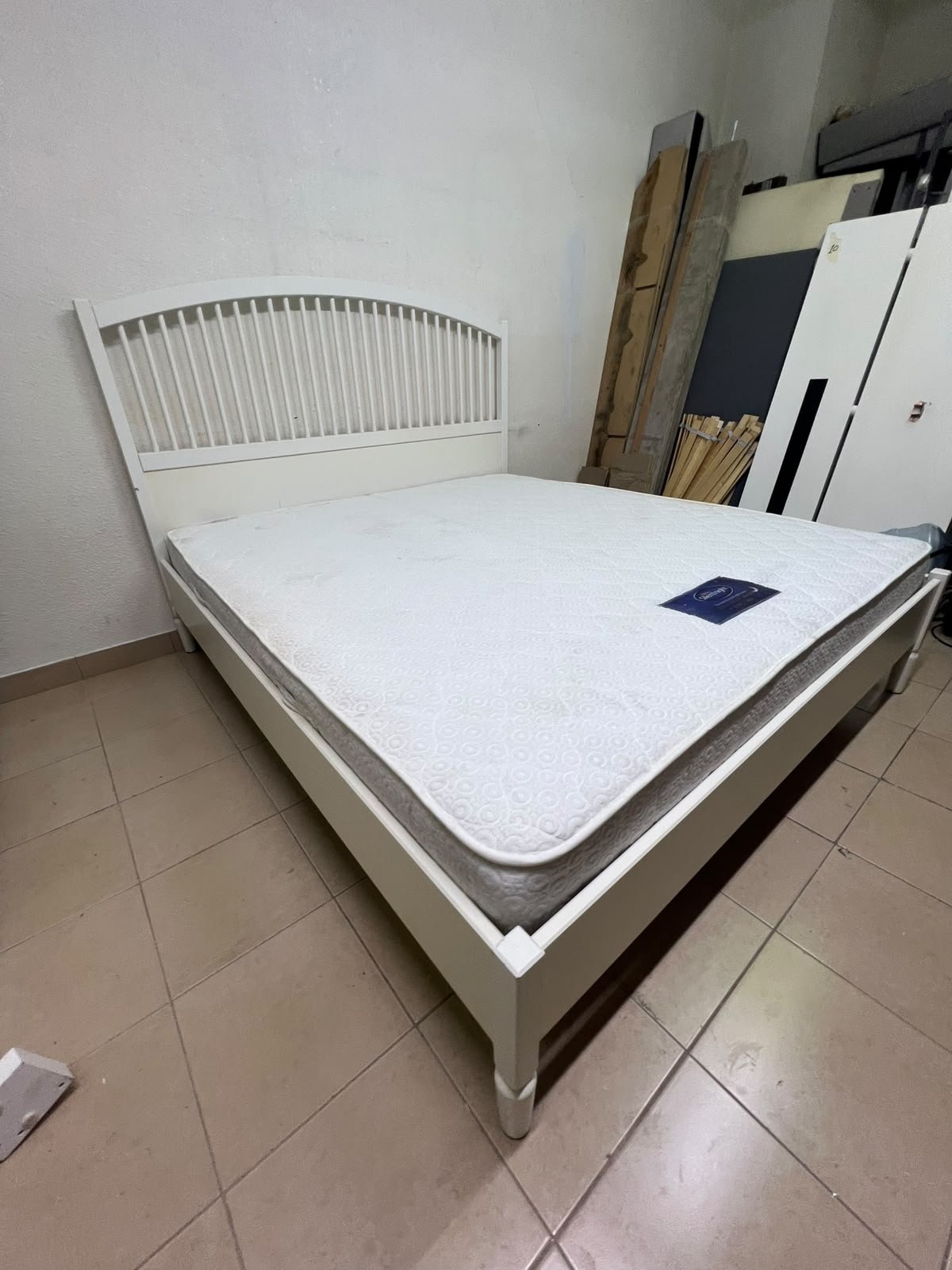 The white IKEA TYSSEDAL bed frame, featuring distinctive vertical wooden slats on the arched headboard and carved legs. - Image 4