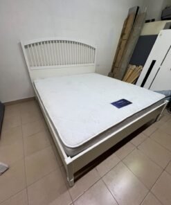 The white IKEA TYSSEDAL bed frame, featuring distinctive vertical wooden slats on the arched headboard and carved legs. - Image 8