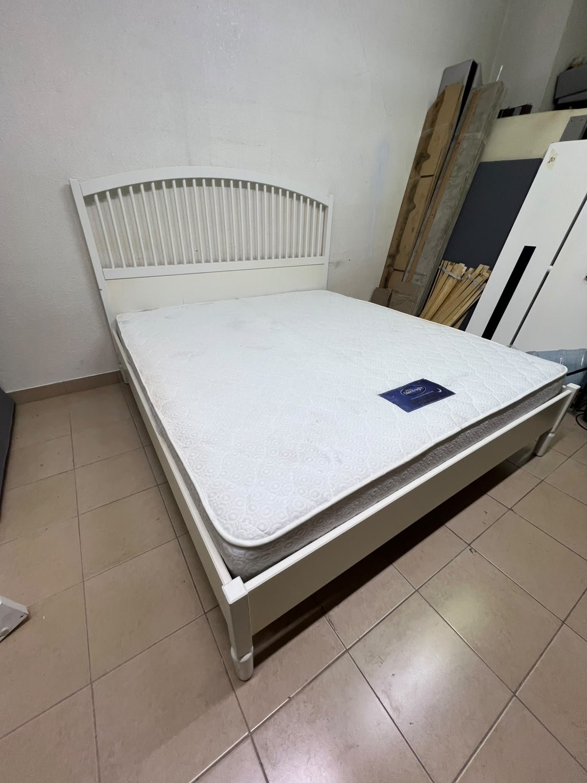 The white IKEA TYSSEDAL bed frame, featuring distinctive vertical wooden slats on the arched headboard and carved legs. - Image 8