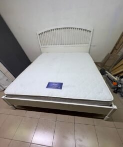 The white IKEA TYSSEDAL bed frame, featuring distinctive vertical wooden slats on the arched headboard and carved legs. - Image 10