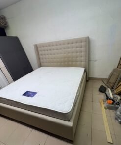 A beige, winged, upholstered bed featuring a button-tufted headboard and nailhead trim. - Image 2