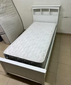 A white wooden single bed frame featuring a headboard with built-in bookshelves, and equipped with a standard padded mattress. - Image 11