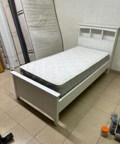 A white wooden single bed frame featuring a headboard with built-in bookshelves, and equipped with a standard padded mattress. - Image 8