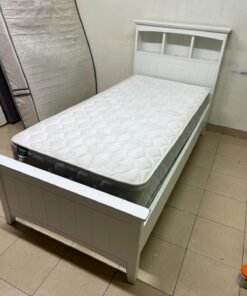A white wooden single bed frame featuring a headboard with built-in bookshelves, and equipped with a standard padded mattress. - Image 9