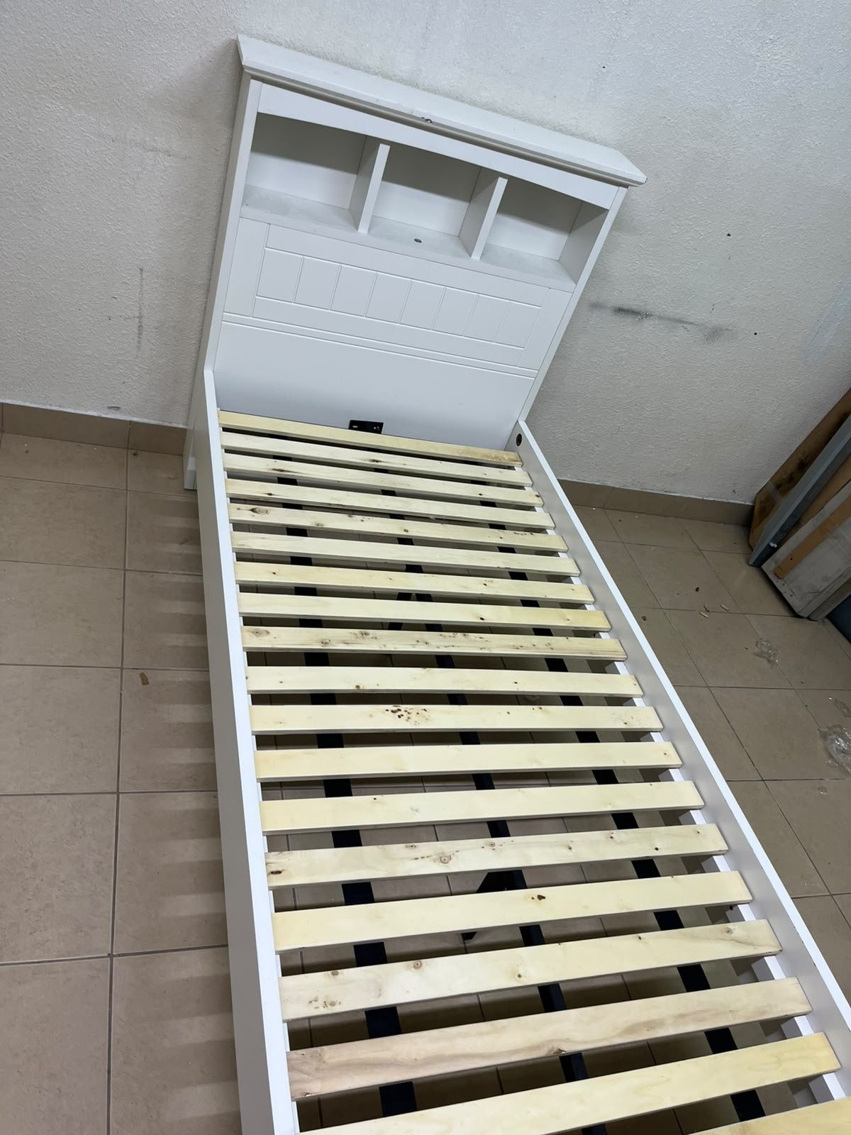 A white wooden single bed frame featuring a headboard with built-in bookshelves, and equipped with a standard padded mattress. - Image 7