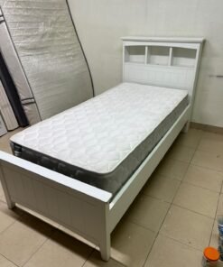 A white wooden single bed frame featuring a headboard with built-in bookshelves, and equipped with a standard padded mattress. - Image 6