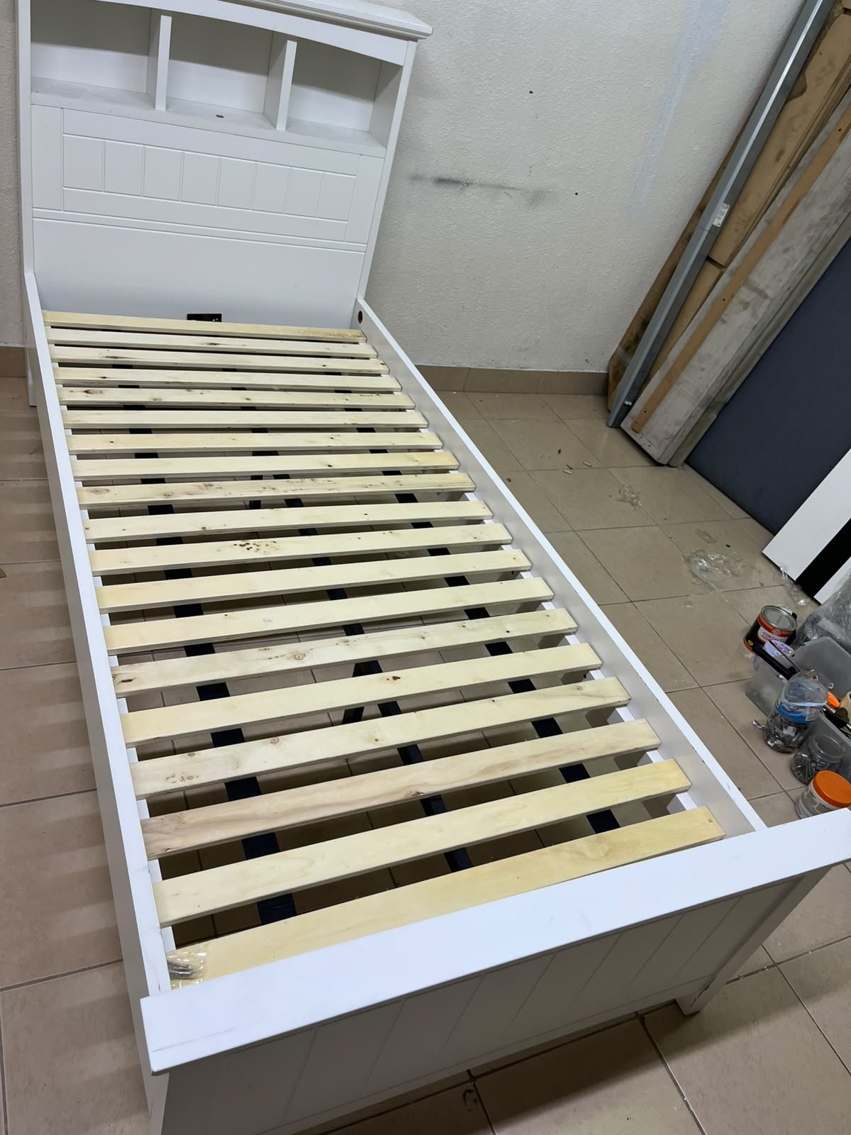 A white wooden single bed frame featuring a headboard with built-in bookshelves, and equipped with a standard padded mattress. - Image 5