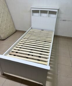A white wooden single bed frame featuring a headboard with built-in bookshelves, and equipped with a standard padded mattress. - Image 4