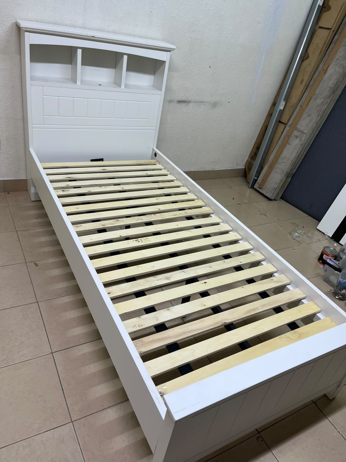 A white wooden single bed frame featuring a headboard with built-in bookshelves, and equipped with a standard padded mattress. - Image 14
