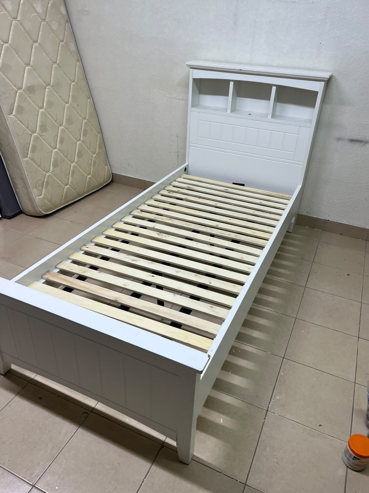 A white wooden single bed frame featuring a headboard with built-in bookshelves, and equipped with a standard padded mattress. - Image 15