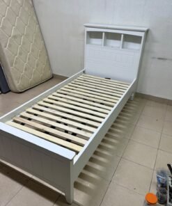A white wooden single bed frame featuring a headboard with built-in bookshelves, and equipped with a standard padded mattress. - Image 16
