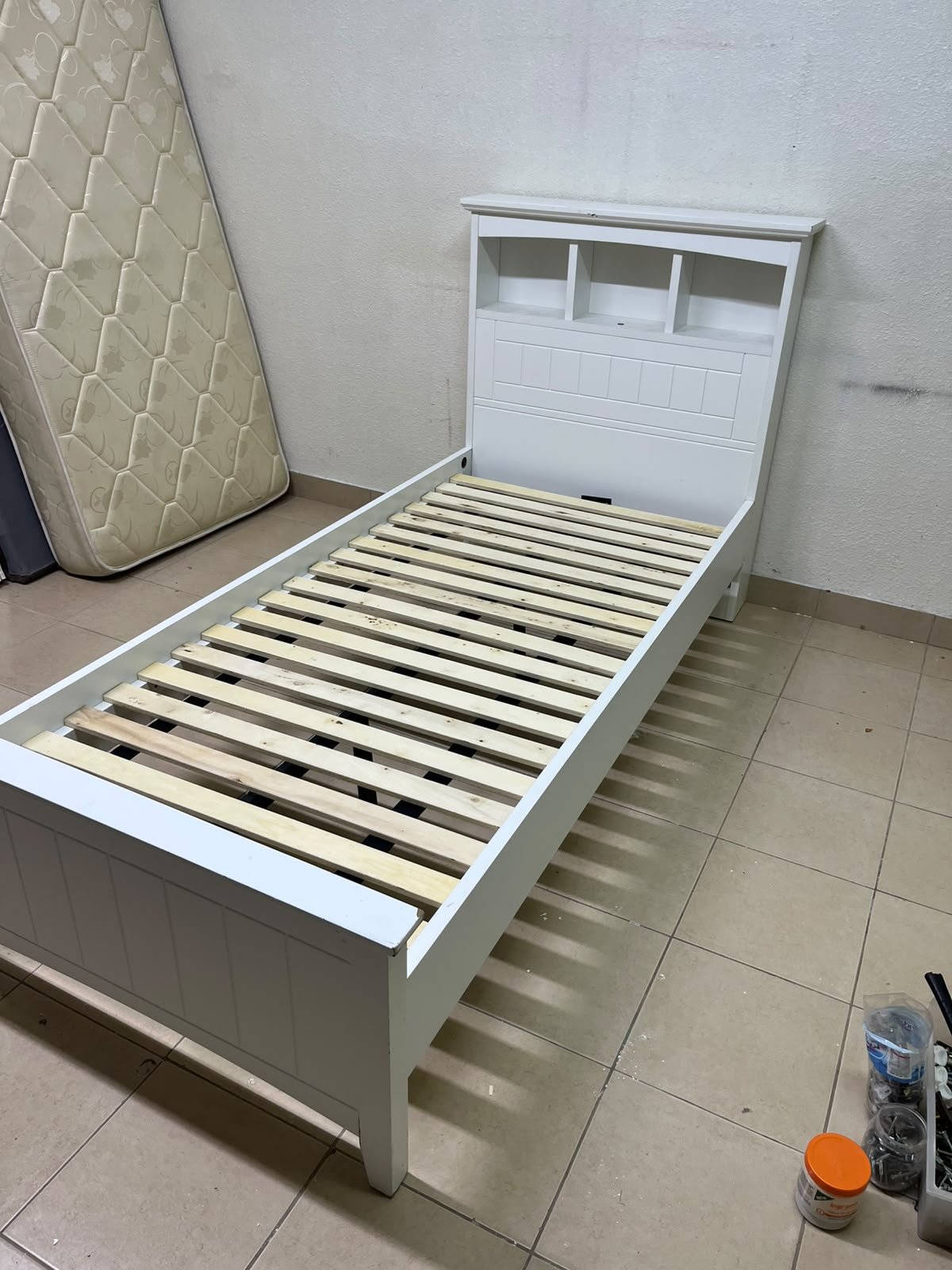 A white wooden single bed frame featuring a headboard with built-in bookshelves, and equipped with a standard padded mattress. - Image 16